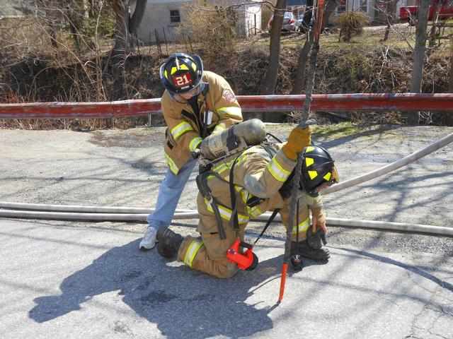 Firefighter Bud Charlton assisting with a cylinder exchange.